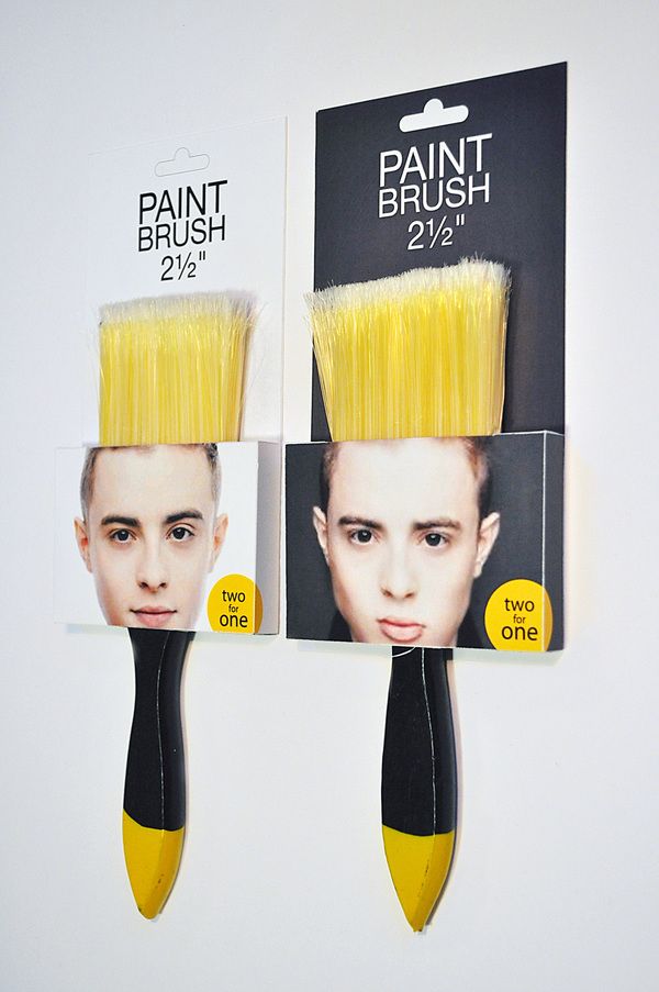Poster: Two paintbrushes packaged as human faces with bristles replacing hair