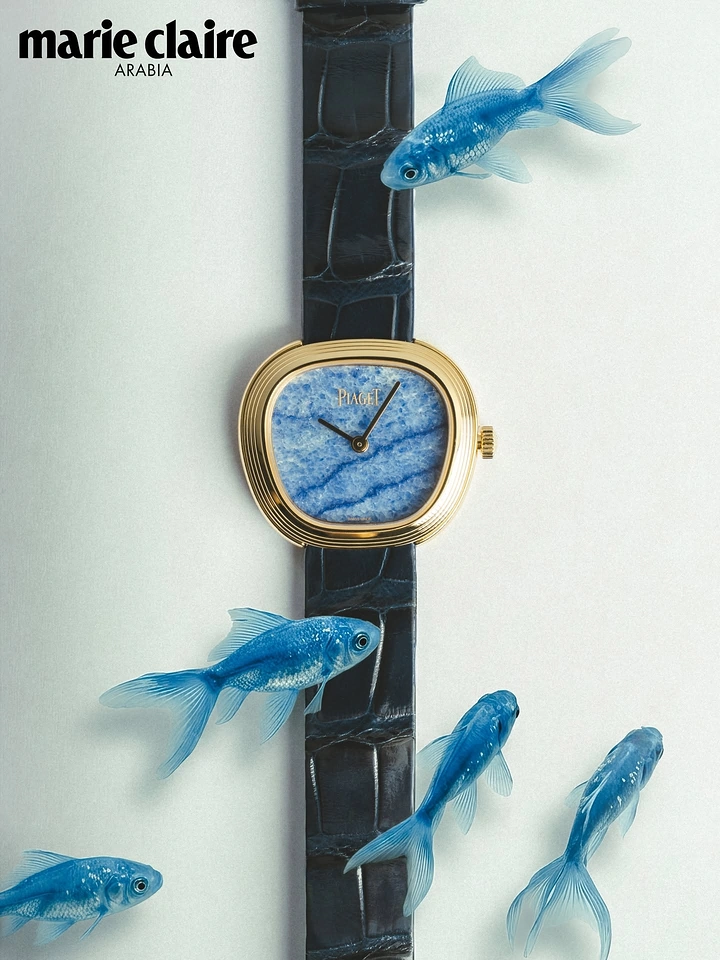 Creative ad: Gold cushion-shaped watch with a blue stone dial, surrounded by blue fish
