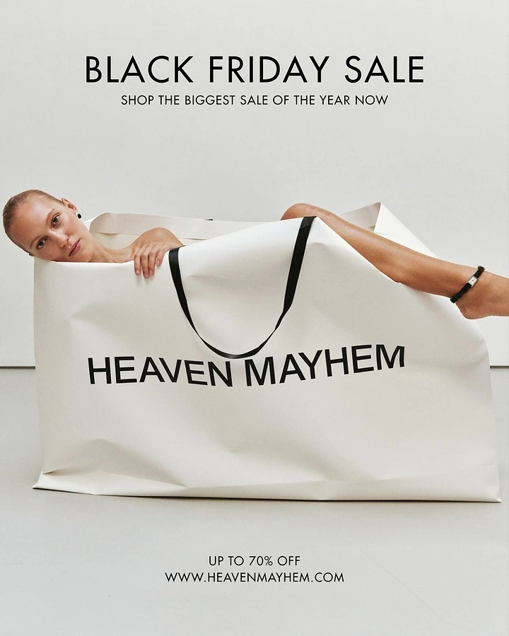 Black Friday creative ad: Model lounging inside a giant branded shopping bag