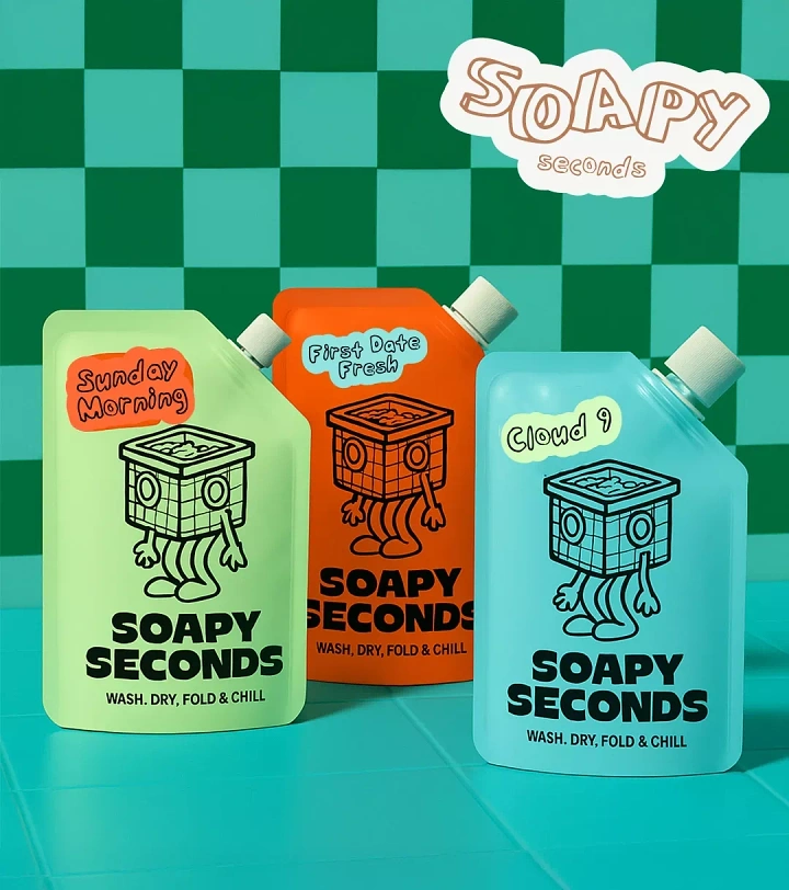 Detergents & Home Cleaning Products creative ad: Three colourful spouted pouches with a cartoon washing-machine mascot