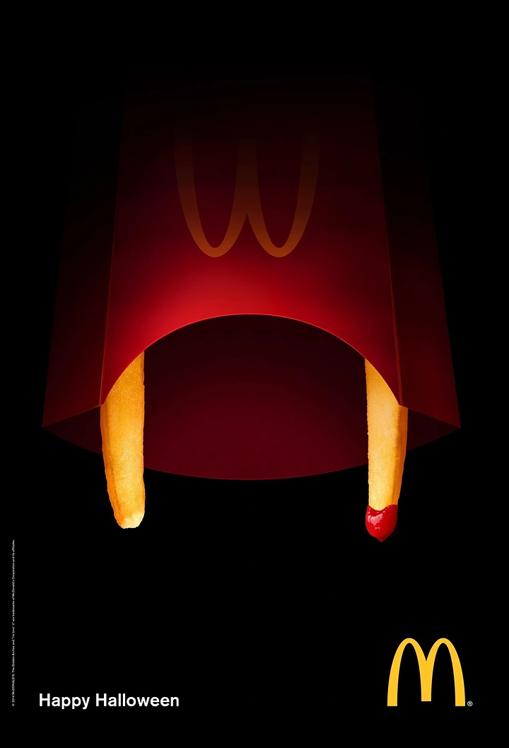 Halloween creative ad: Fry carton with two fries as vampire fangs, one dipped in ketchup