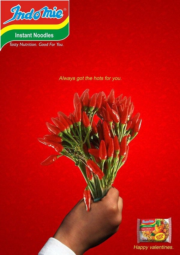 Valentine's Day creative ad: Hand holding out a bouquet of red chillies like flowers