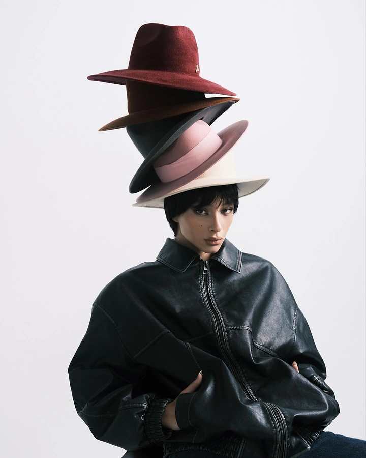 Hats & Caps creative ad: Unexpected stacked-hat fashion portrait