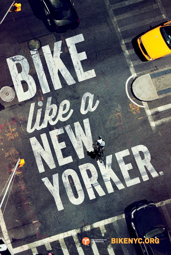 Poster: Top-down view of a city intersection with the headline painted on the asphalt