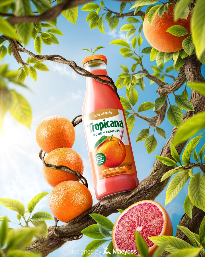 Creative ad: Juice bottle wrapped by tree branches among oranges
