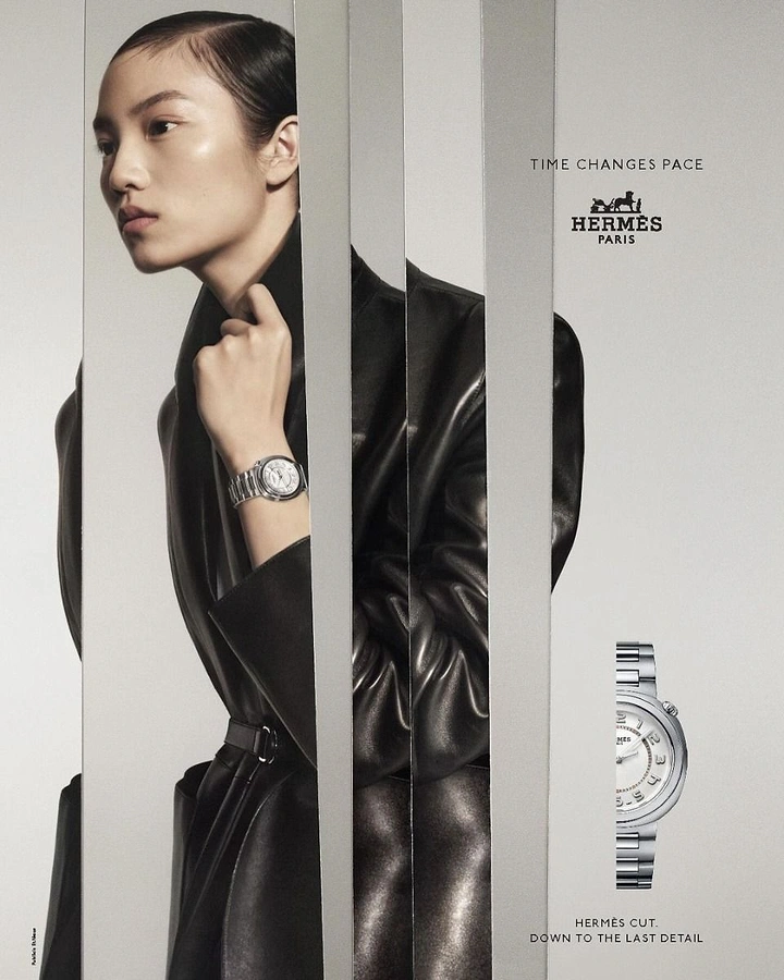 Creative ad: Model in black leather coat seen through vertical mirror slices wearing a steel watch