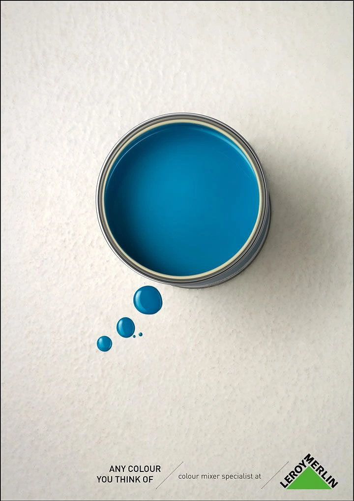 Construction creative ad: Top-down open blue paint can with droplets forming a thought bubble