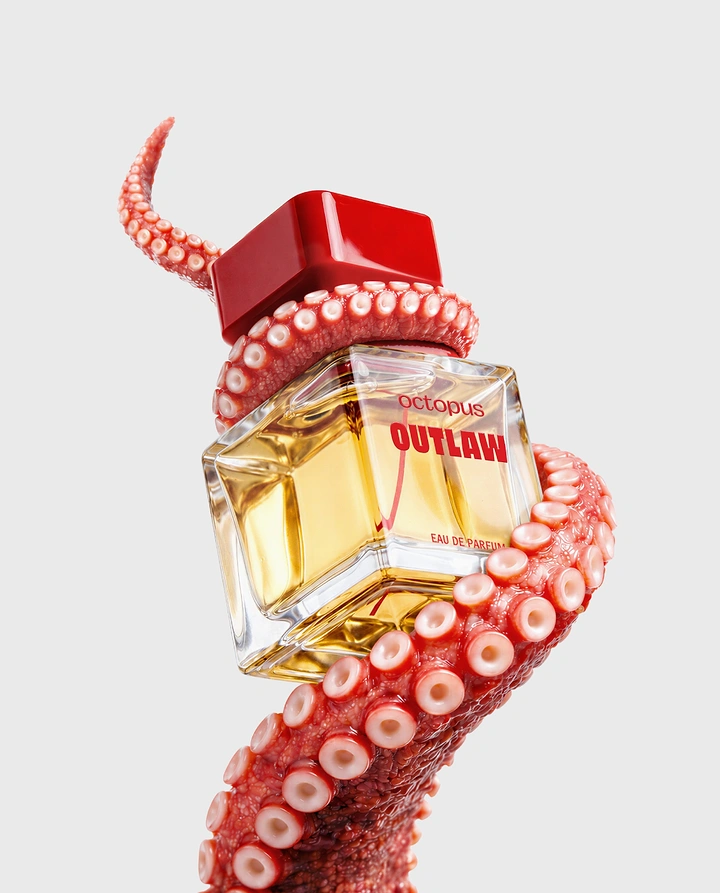 Perfume & Fragrance creative ad: Red octopus tentacle coiled around a tilted cube perfume bottle