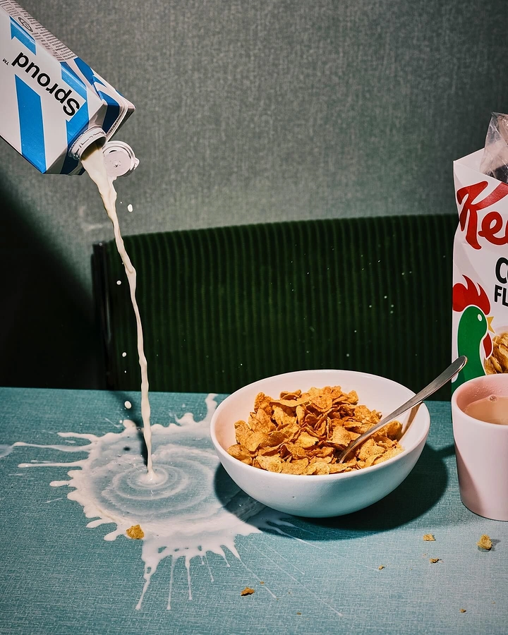 Breakfast Cereals & Oats creative ad: Milk spill creates unexpected cereal composition