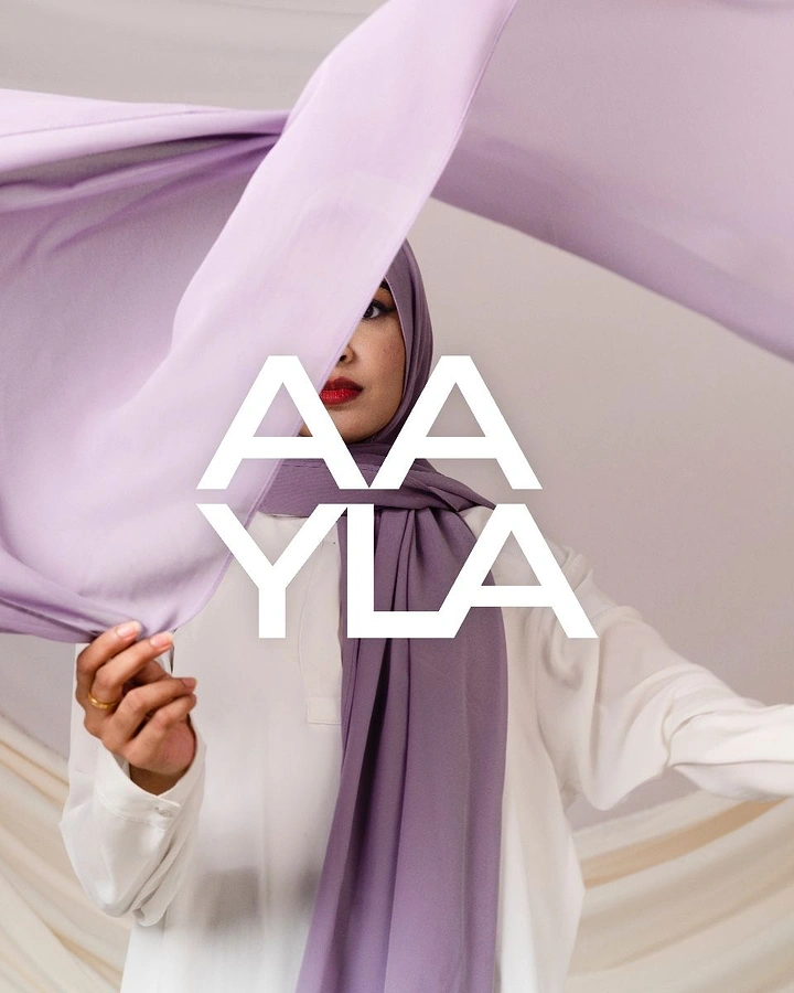 Modest Fashion, Hijabs & Abayas creative ad: Woman in lilac hijab waving a billowing chiffon scarf
