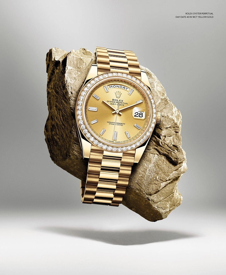 Watches & Accessories creative ad: Gold diamond-set wristwatch wrapped around a floating rock