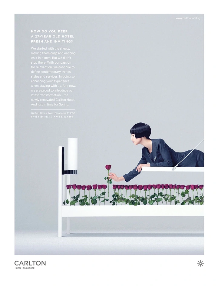 Creative ad: Uniformed woman plucking a rose from a bed frame planted with roses