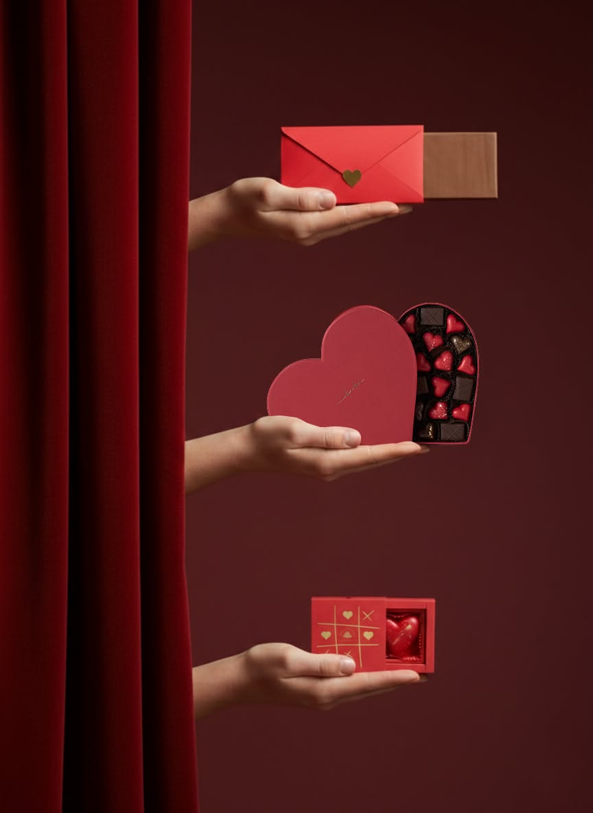 Valentine's Day Instagram post: Three hands emerging from a velvet curtain offering chocolate gifts