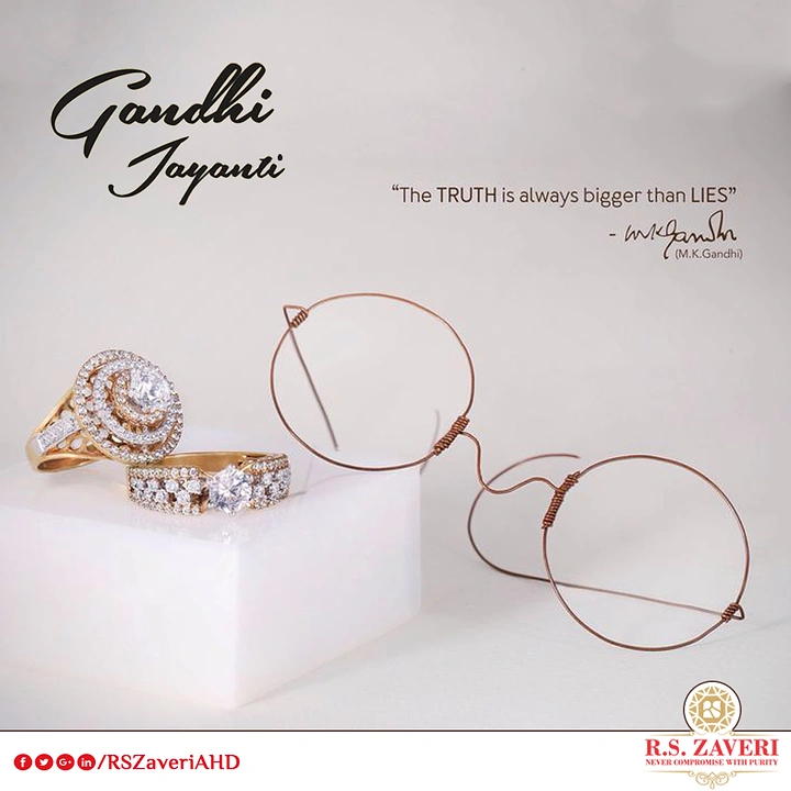 Gandhi Jayanti creative ad: Diamond rings on marble block beside copper-wire round spectacles