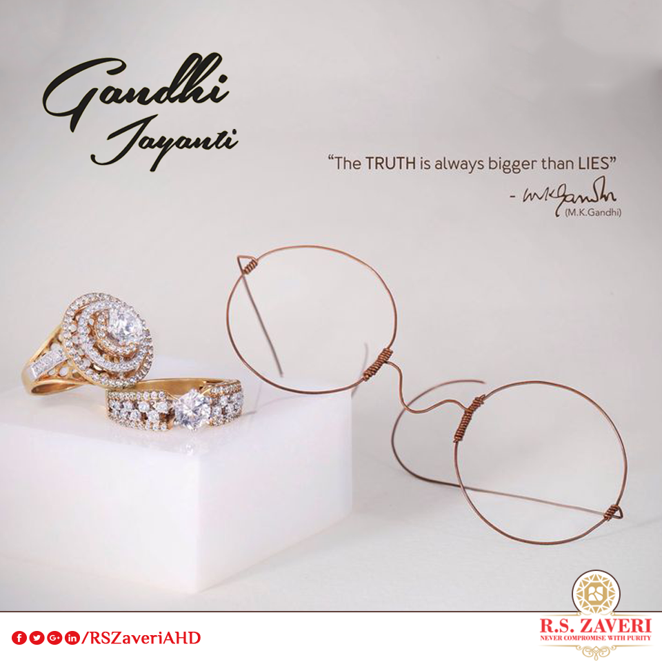 Diamond rings on marble block beside copper-wire round spectacles