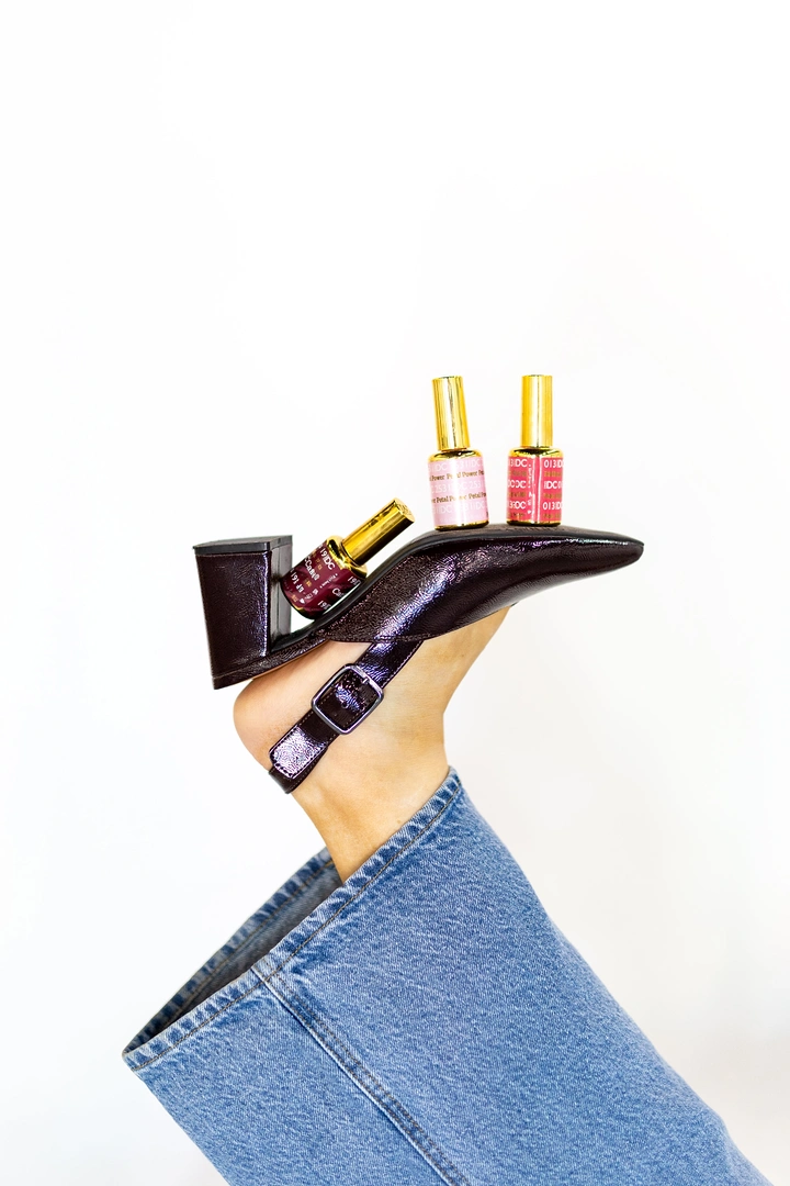 Nail Salons creative ad: Polish bottles perched on heeled shoe