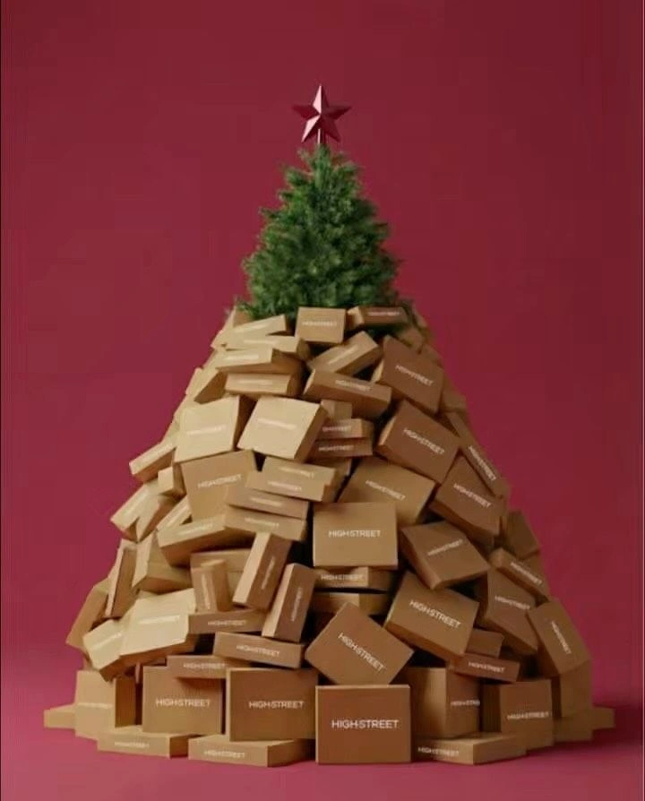 Christmas creative ad: Christmas tree formed from a pile of branded kraft boxes