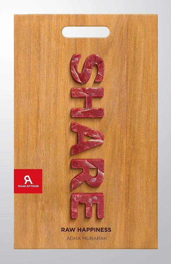 Eid creative ad: Word spelled in raw meat cutouts on a wooden cutting board
