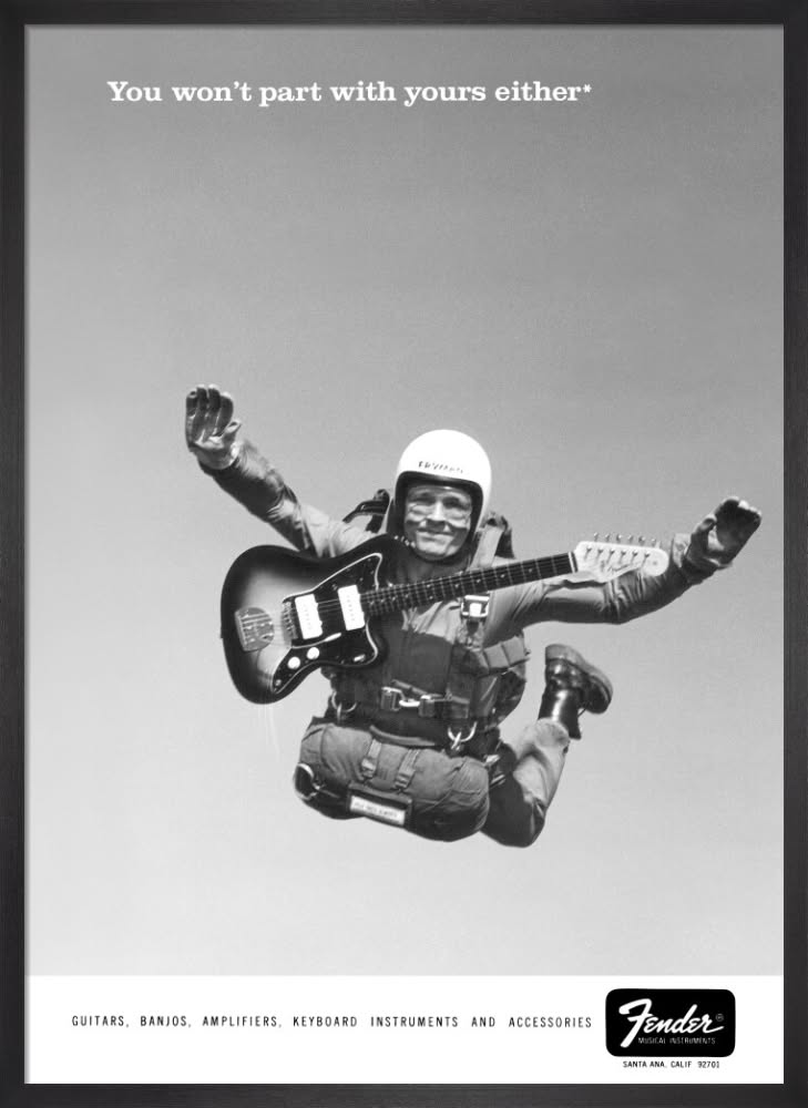 Story: A smiling skydiver floating through the air while playing an electric guitar