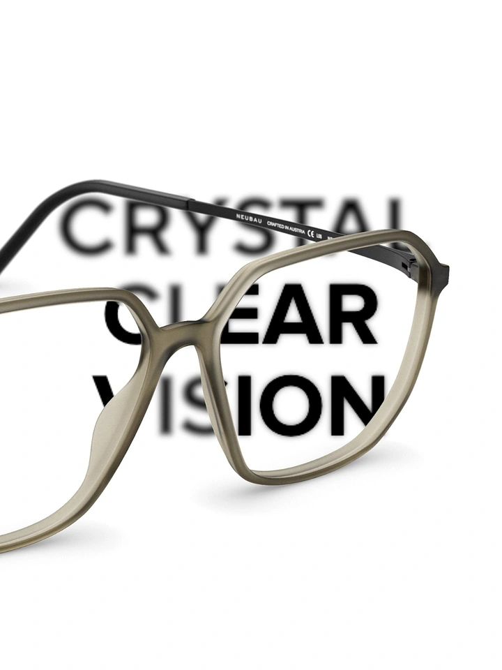 Opticians & Eye Care creative ad: Close-up of taupe eyeglass frames with the text sharp through the lens