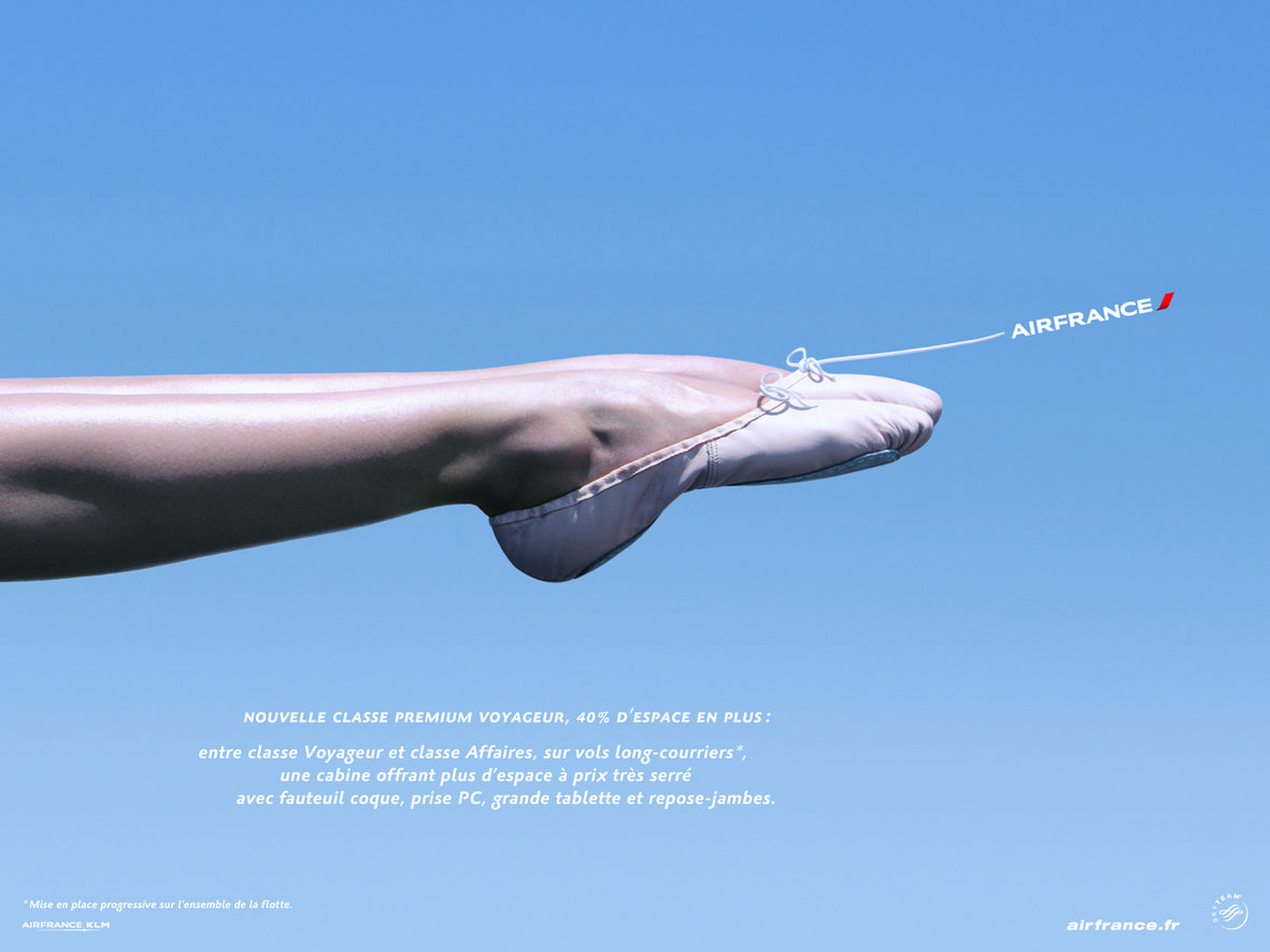 Poster: Dancer's extended leg in pointe shoe against sky, mimicking aircraft fuselage
