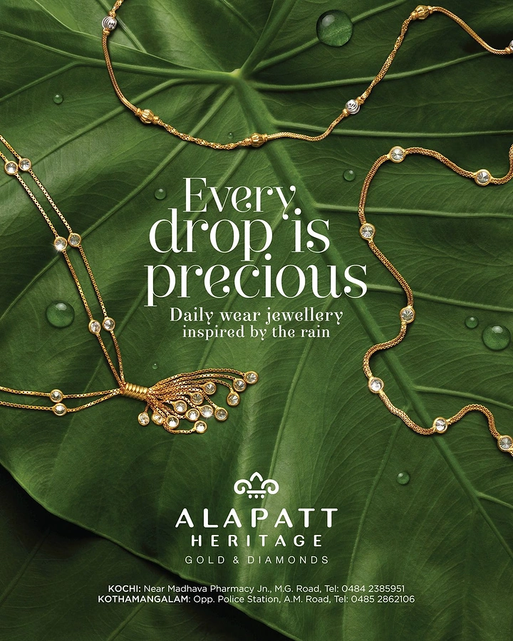 Creative ad: Gold chains draped across a dew-covered green leaf