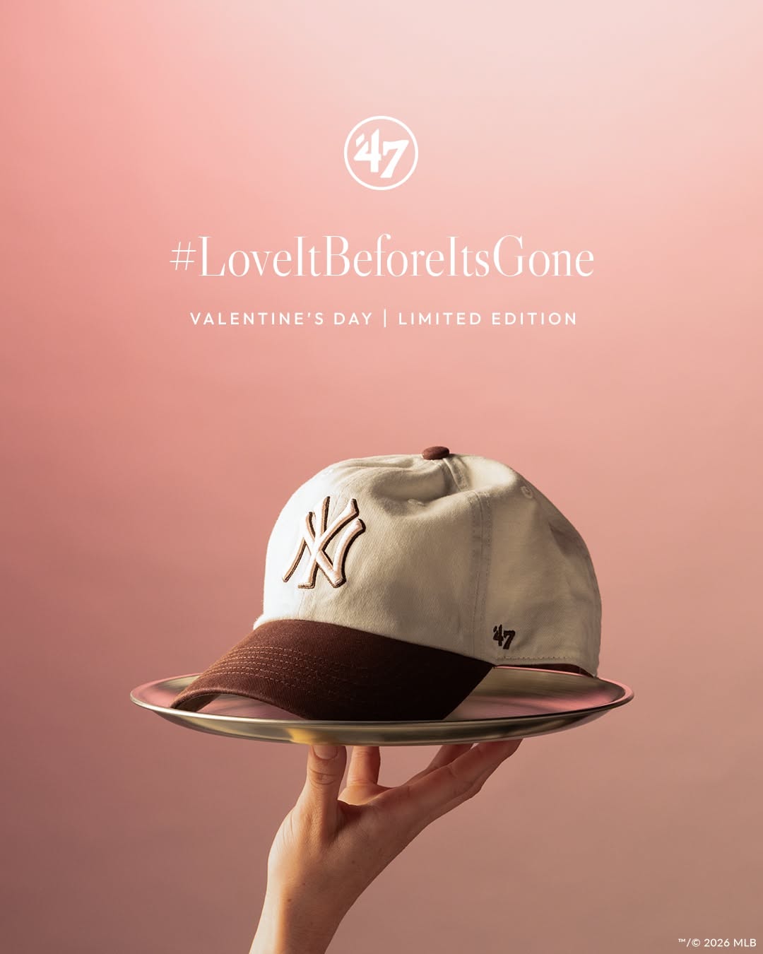 Valentine's Day Instagram post: Cream and brown baseball cap served on a silver tray held aloft