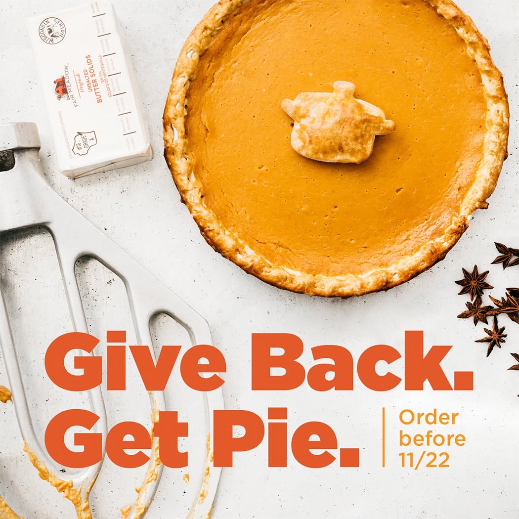Overhead whole pumpkin pie with baking props