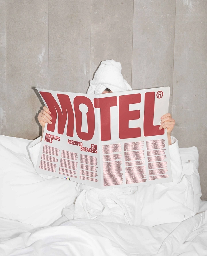 Printing Shops creative ad: Person in bed with a towel on their head, hidden behind a newspaper