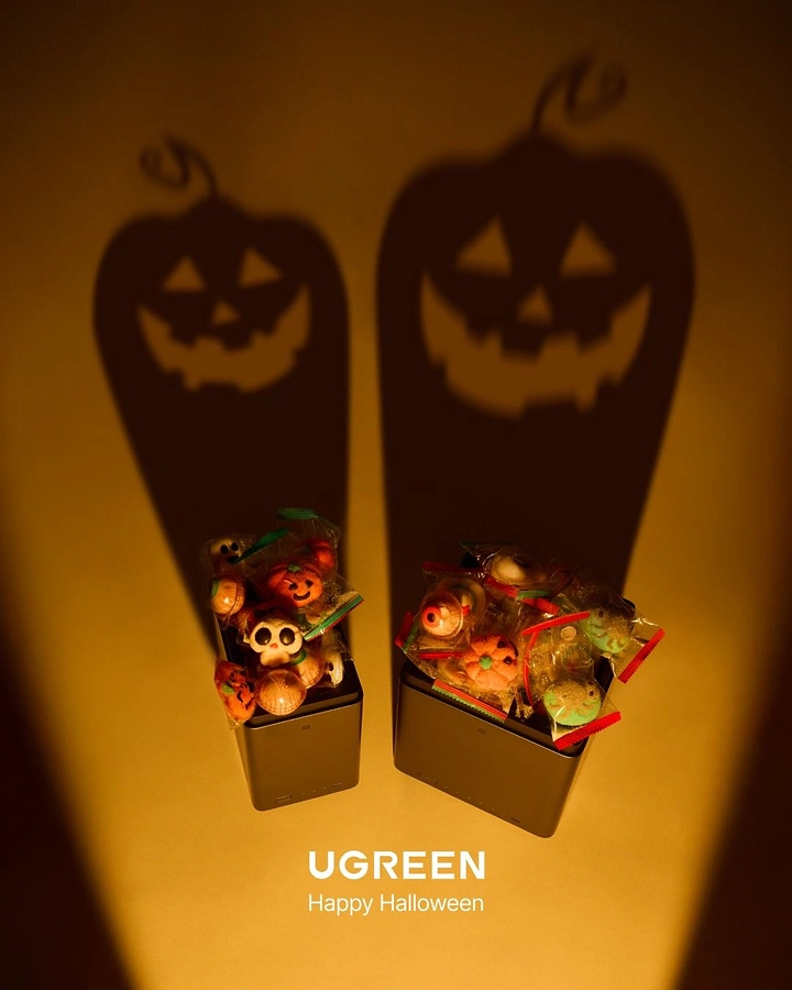 Halloween creative ad: Two devices filled with candy casting jack-o'-lantern shadows
