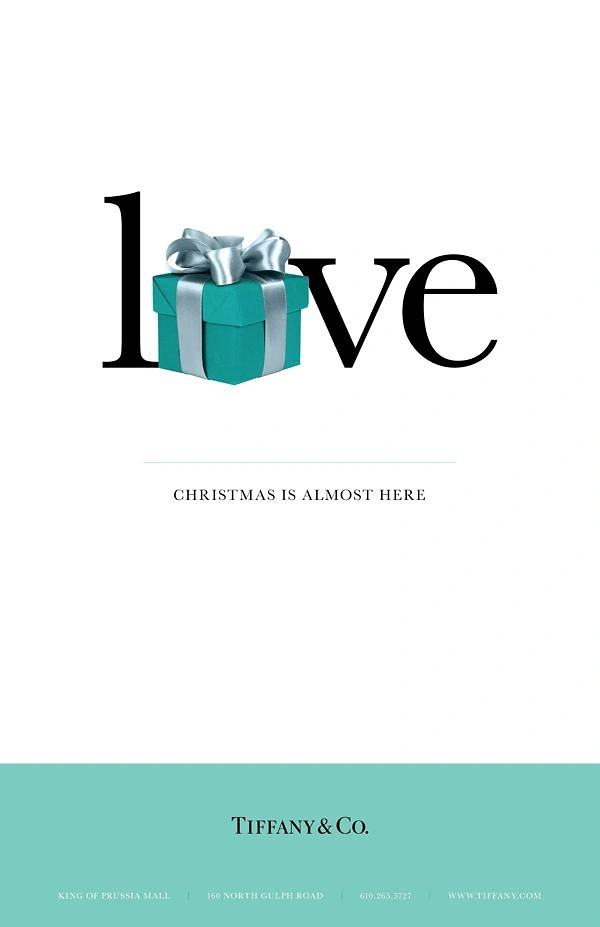 Christmas creative ad: Teal gift box replacing the letter o in a word