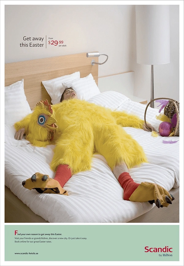 Easter creative ad: Exhausted man in a yellow chicken costume sprawled on a hotel bed