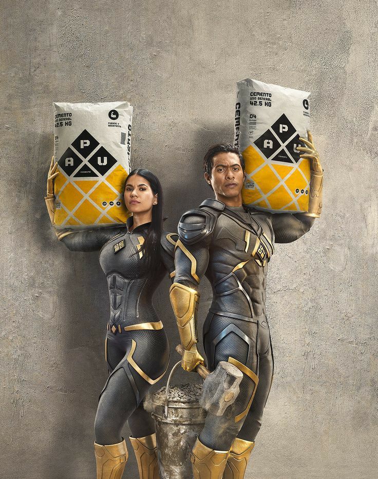 Instagram post: Two superhero-suited workers holding cement bags on their shoulders