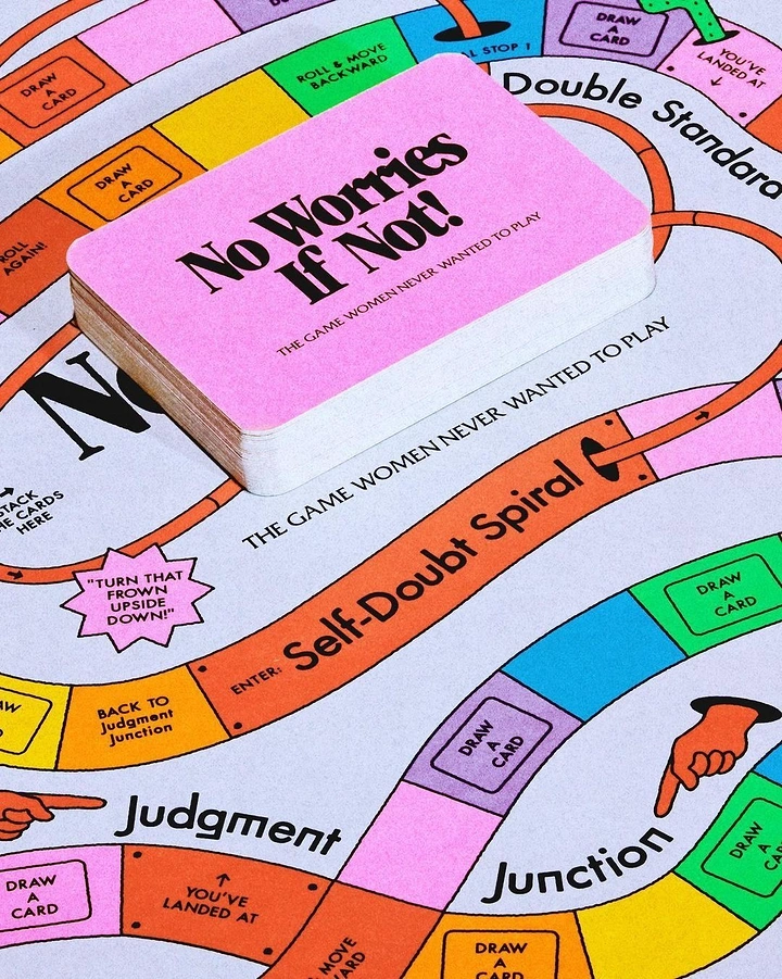 Board Games & Game Cafes creative ad: Pink card deck resting on a colourful winding game board