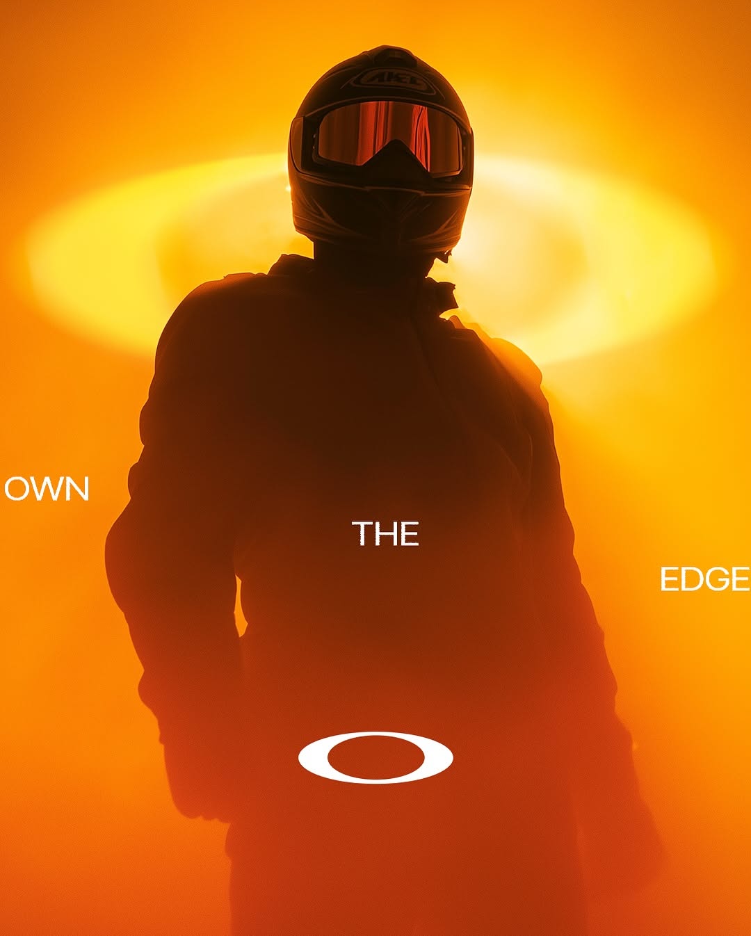 Carousel: Silhouetted figure in beanie and balaclava wearing mirrored orange wraparound shades, slide 5