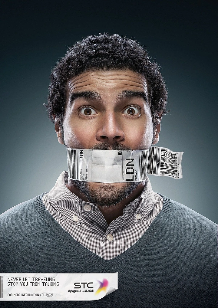 Telecom creative ad: Wide-eyed man with an airline luggage tag taped over his mouth