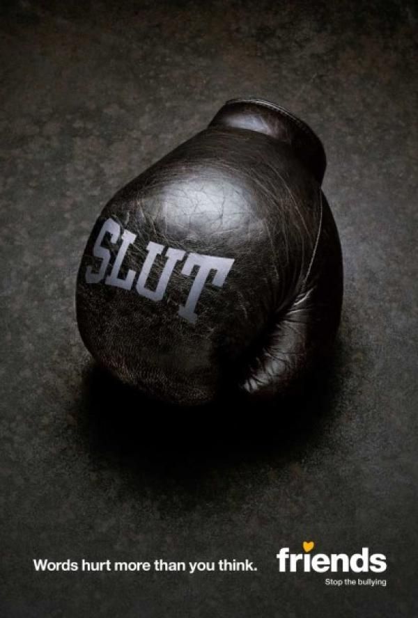 Worn black leather boxing glove with an insult printed on it