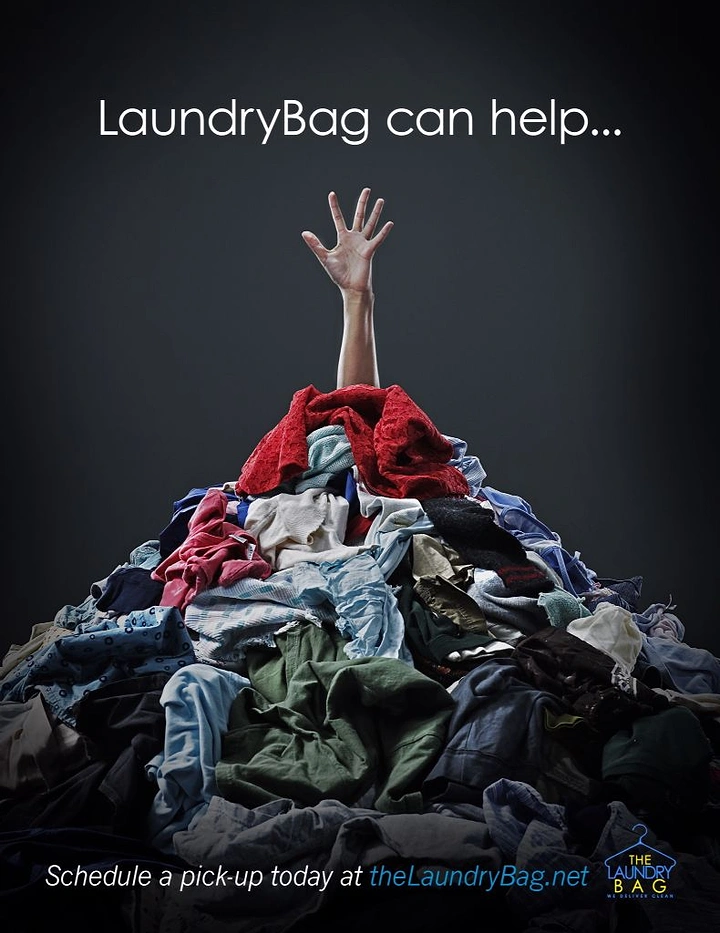 Laundry & Dry Cleaning creative ad: Hand drowning in laundry pile metaphor