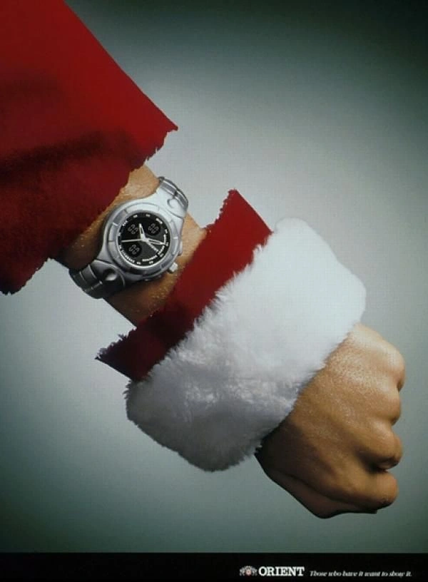 Christmas creative ad: Santa's hand pulling back his red fur-trimmed sleeve to show a silver sports watch