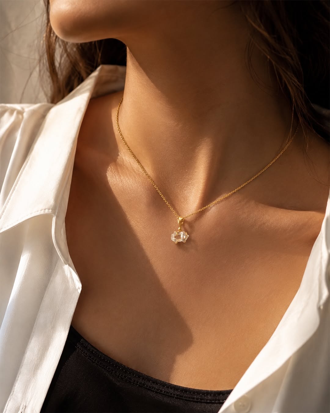 Carousel: Woman in white shirt and jeans crossing a street, with jewelry close-up callouts, slide 3
