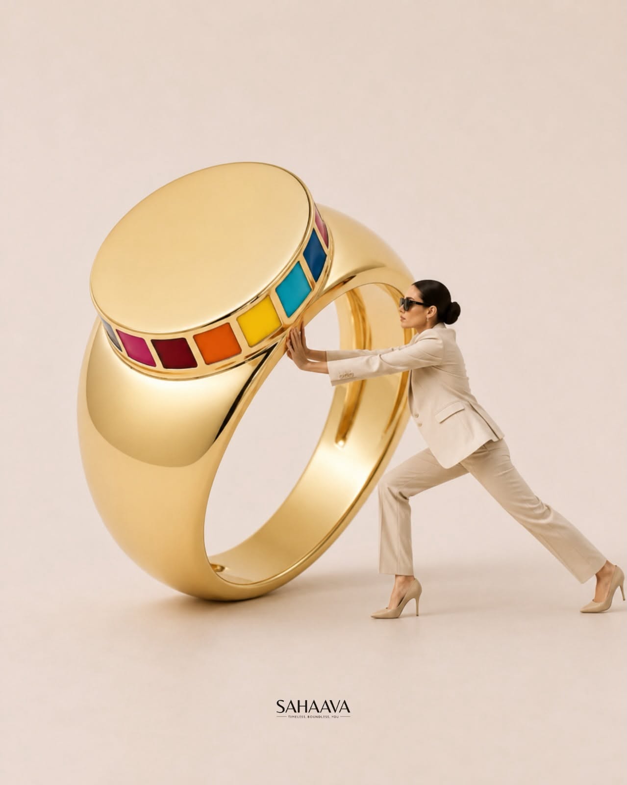 Woman in a cream suit sitting on a giant gold ring pendant