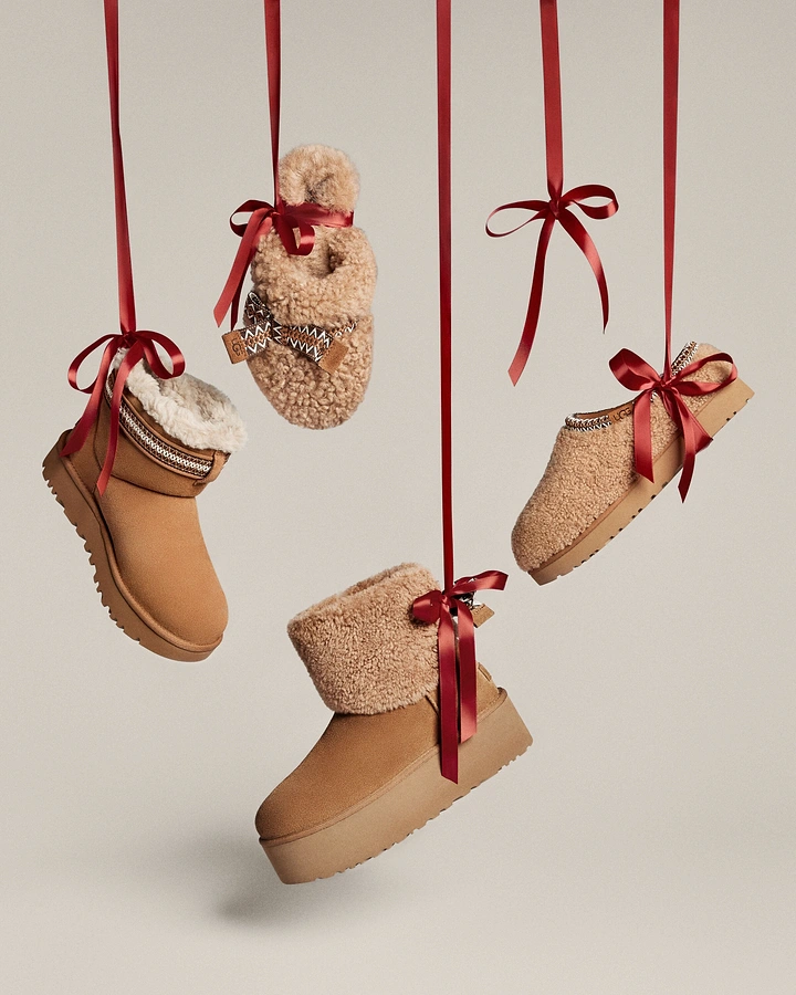 Christmas creative ad: Shearling boots and slippers hanging from red ribbons