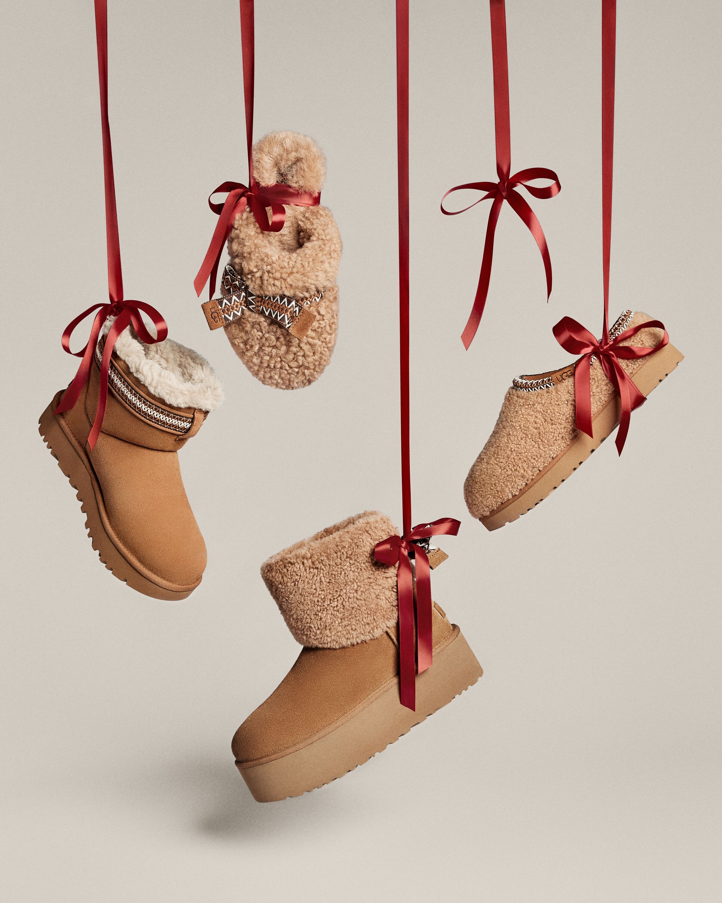 Christmas Instagram post: Shearling boots and slippers hanging from red ribbons