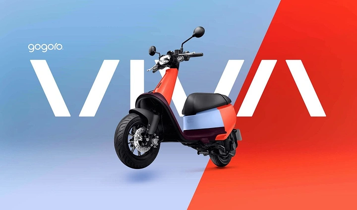 Electric Vehicles creative ad: Coral and light-blue electric scooter at three-quarter angle in front of a giant wordmark