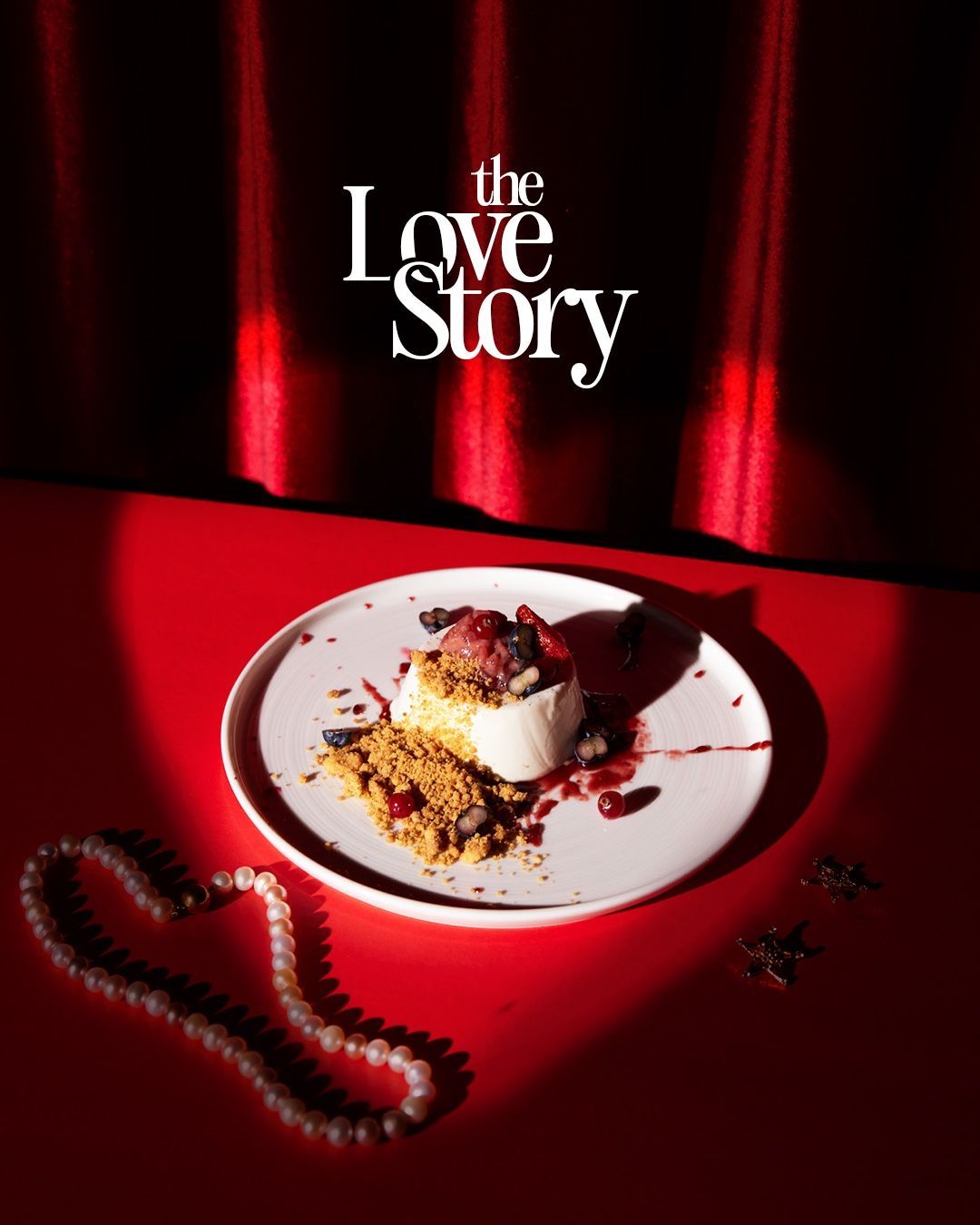 Valentine's Day Instagram post: Plated panna cotta dessert with berries and crumble under a spotlight