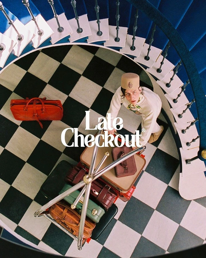 Streetwear creative ad: Top-down shot of bellhop with luggage cart on checkered floor