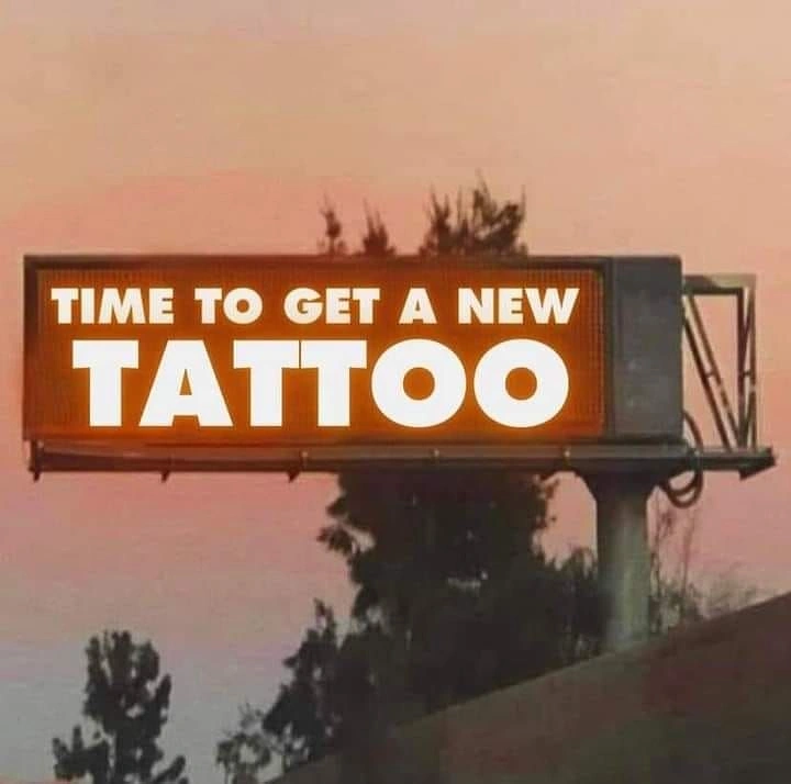 Tattoo Studios creative ad: Glowing billboard at dusk, cinematic nudge