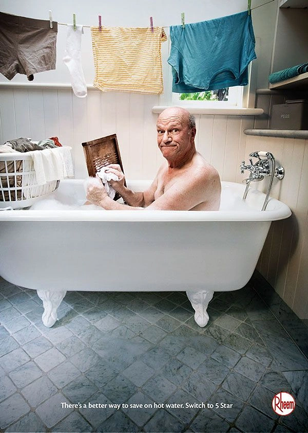 Plumbers creative ad: Man bathing in laundry tub, hot-water humour
