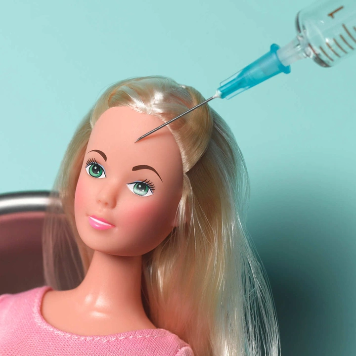 Plastic Surgery Clinics creative ad: Barbie injection visual metaphor