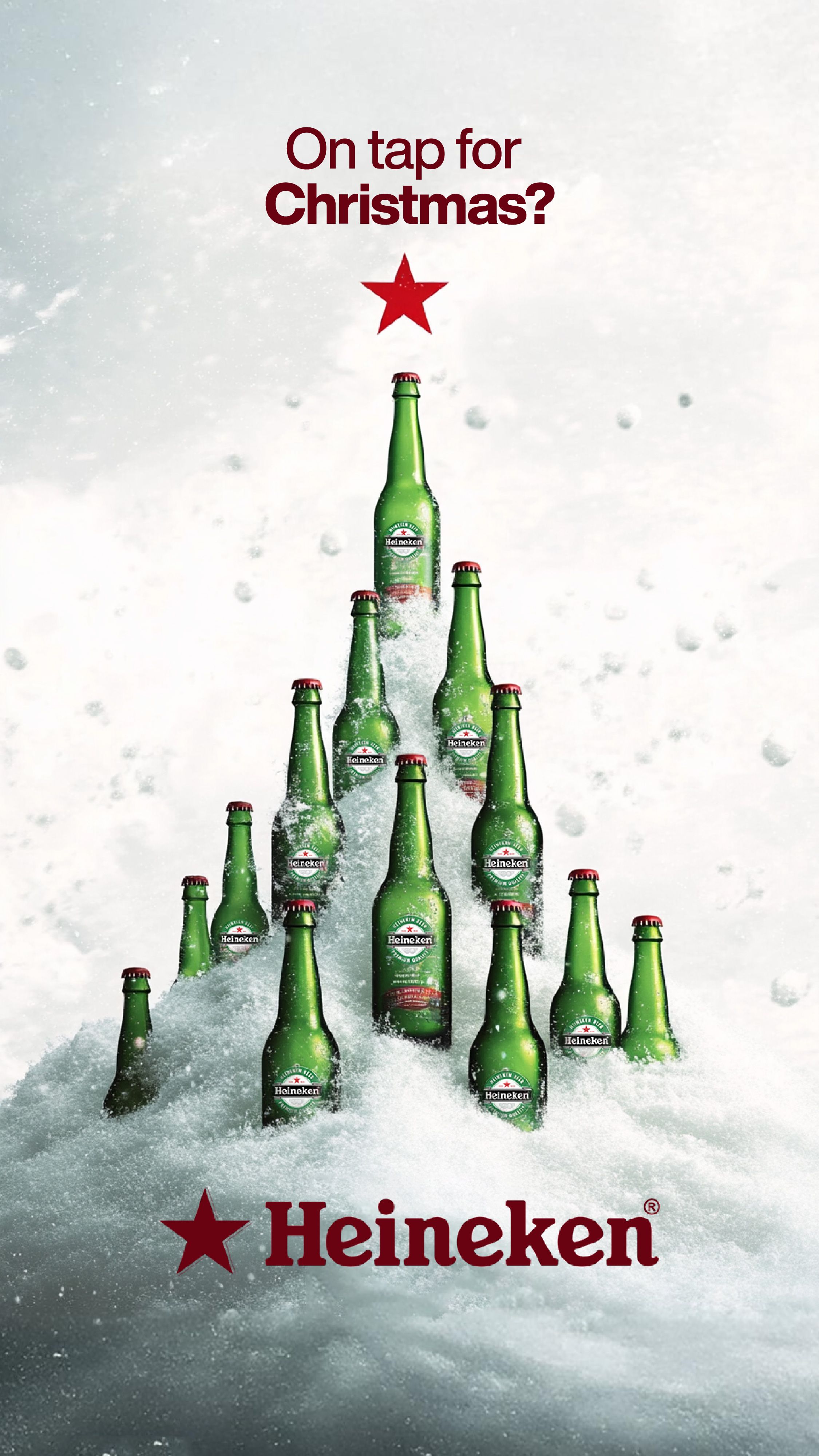 Green beer bottles arranged in snow as a Christmas tree